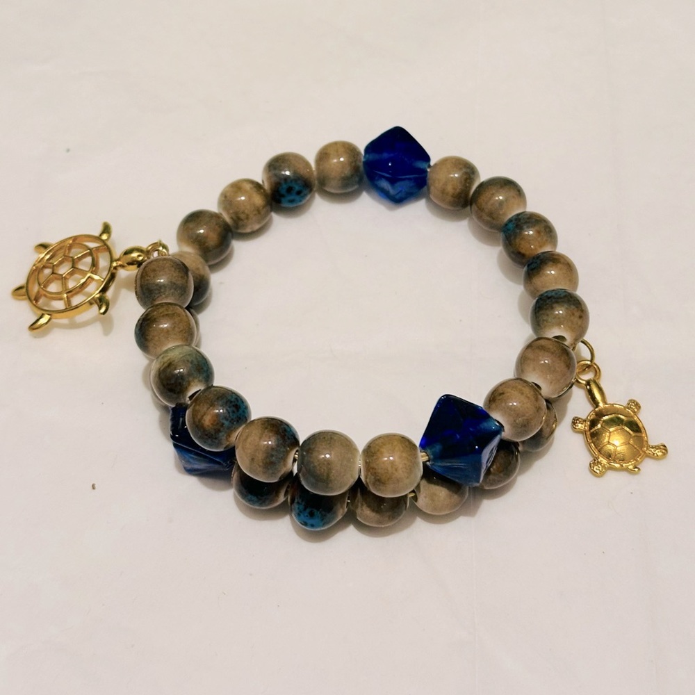 Handmade Blue/Brown Bracelet. Gorgeous Turtles Charm.Made with Memory Gold Wire.